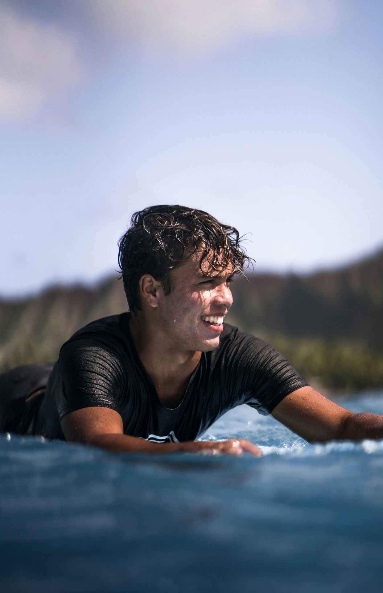 young man riding on a boogie board on the ocean on the Big Island of Hawaii
