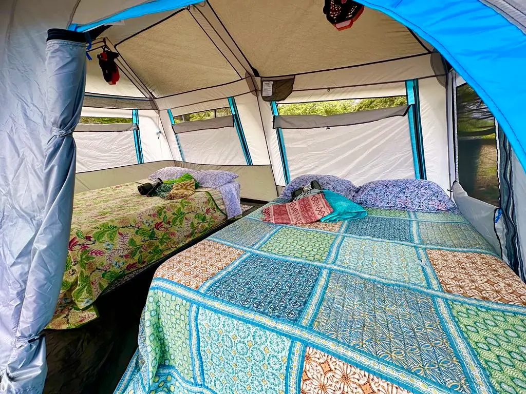tent set up with two luxury queen air mattresses, solar fans, bedding, 
