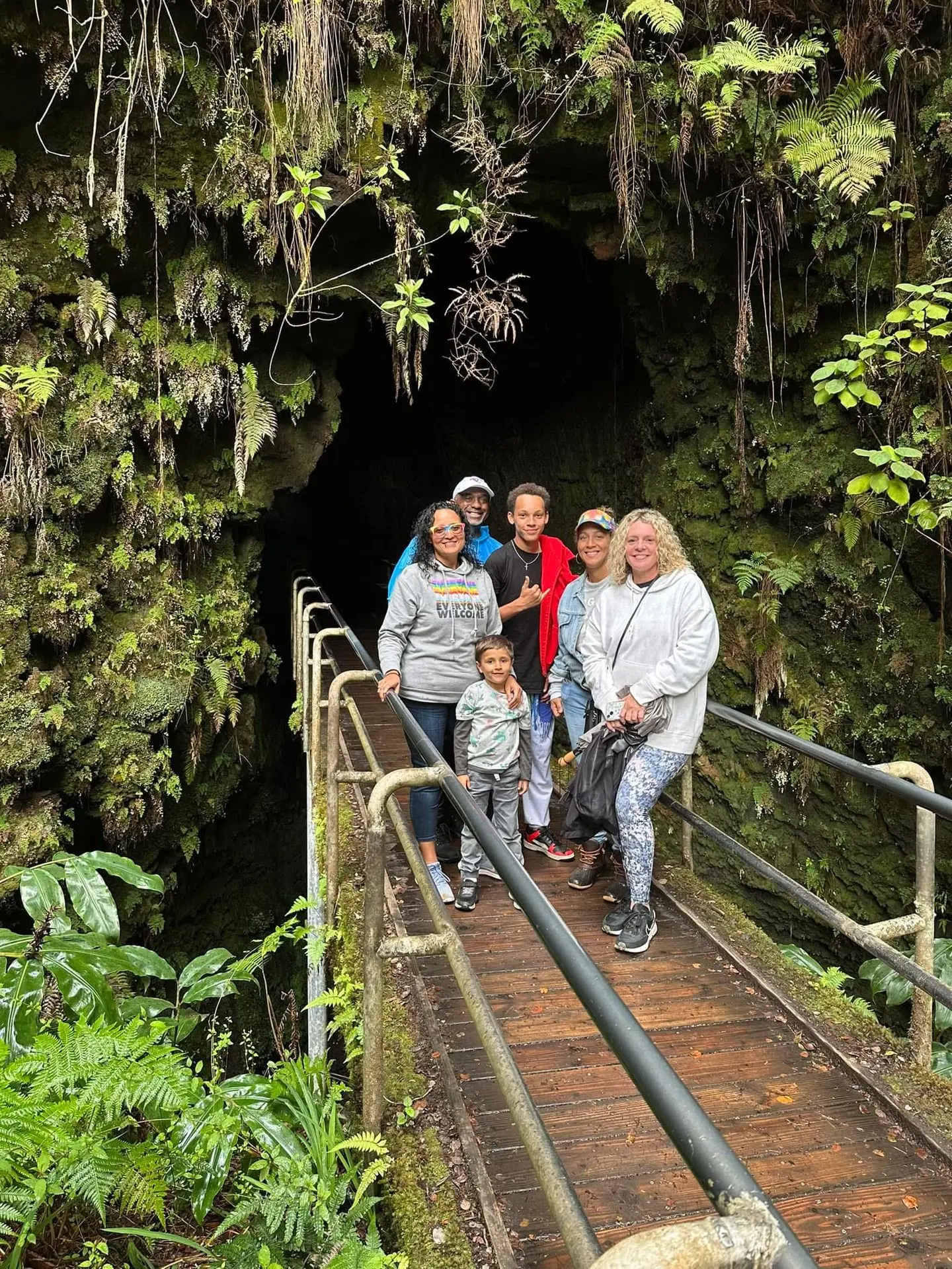 happy family standing in front of volcano national park thurston lava tube Nāhuku Lava Tube